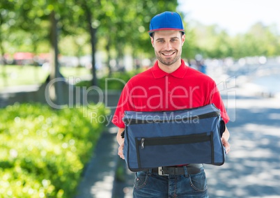 Pizza deliveryman with blue hat and delivery bag in the park