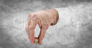 Hand with coins against white grunge background