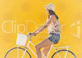 Woman on bike against yellow sun pattern