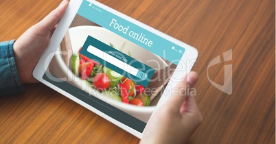 Hand ordering food on digital tablet with search screen on it