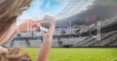 Woman touching blank screen of mobile phone at stadium
