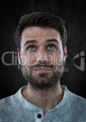 Man looking up against black wall