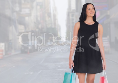 Walking woman with shopping bags in city