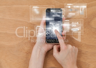 Overhead of hands with phone and white interface with flare