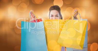 Portrait of woman with shopping bags over bokeh