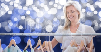 Woman choosing clothes over blur background