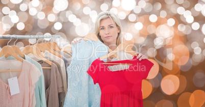 Woman choosing tops over bokeh