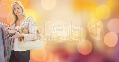 Portrait of woman holding wallet while shopping over bokeh