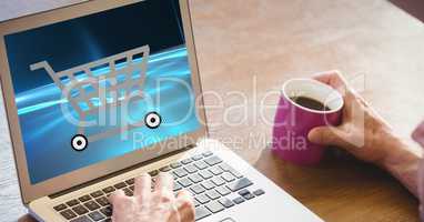Cropped image of person shopping online while having coffee