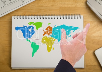 Hand over Colorful Map on a notepad