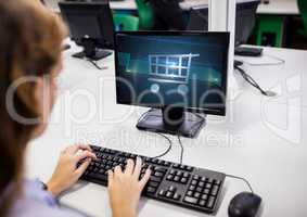 Woman using computer with Shopping trolley icon
