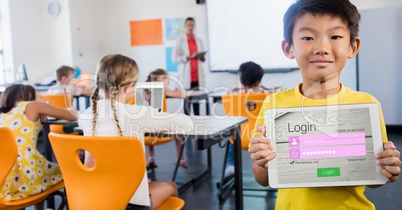 Schoolboy showing log in page on device in classroom