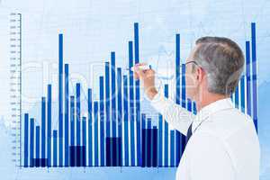 Digital composite image of businessman preparing bar graph