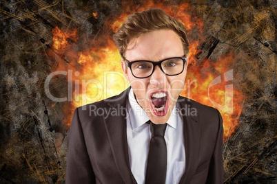 Digital composite image of angry businessman with fire in background