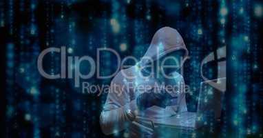 Digital composite image of hacker using credit card and laptop