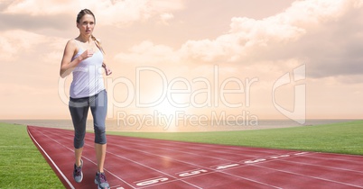 Digital composite image of female running on tracks