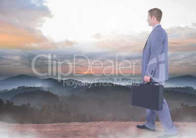 Businessman walking on mountain