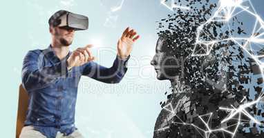 3D black male AI and man sitting in VR with flare on finger against blue background with white netwo