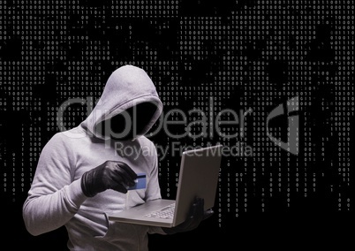 Anonymous Criminal in hood on laptop in front of numbers