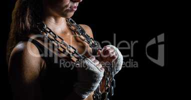 Woman with chains against black background