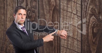 Confident businessman showing time on wristwatch