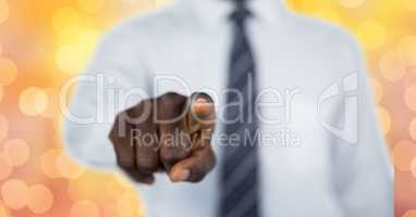 Midsection of businessman pointing over bokeh