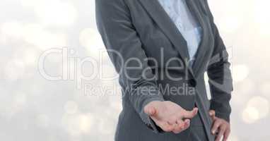 Midsection of businesswoman gesturing over blur background