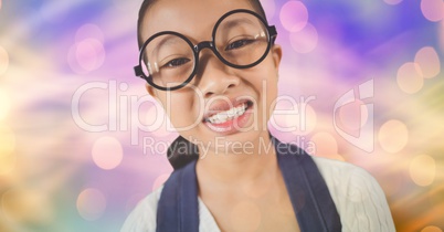 Little girl wearing eyeglasses over blur background