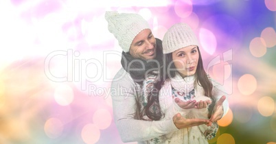 Loving couple with snow over bokeh