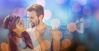 Smiling man looking at woman over bokeh