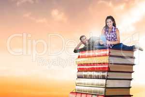 Composite image of couple on books