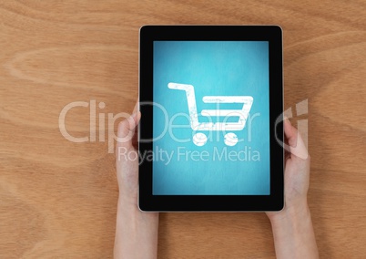 Person using Tablet with Shopping trolley icon