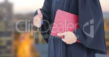 Judge holding book in front of city