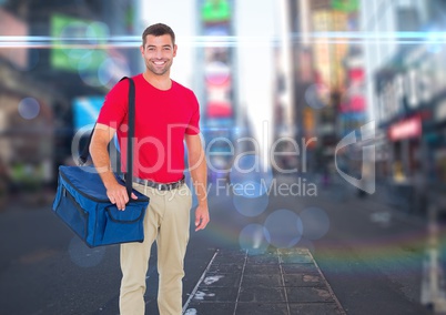 Happy pizza deliveryman with delivery bag in the city with lights