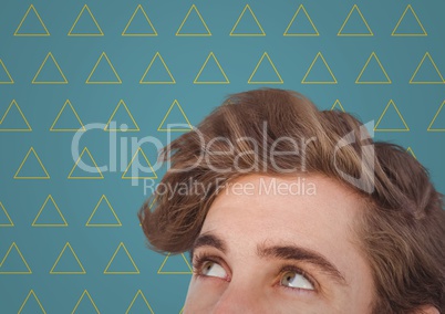 Top of man's head against blue background with yellow triangle pattern