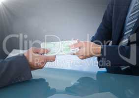 Business money exchange at blue desk against navy background with flare