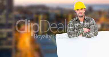 Architect leaning on bill board in city