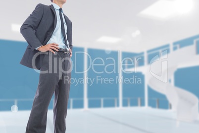 Midsection of businessman standing with hands on hips