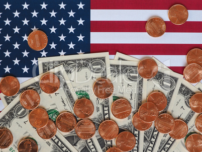 Dollar notes and coins and flag of the United States