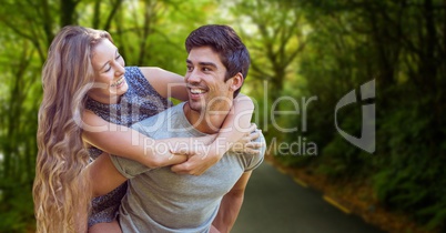 Happy man piggybacking woman