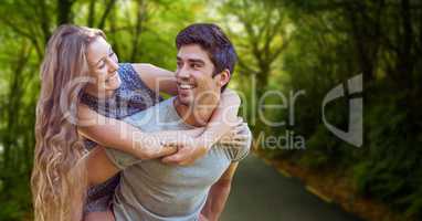 Happy man piggybacking woman