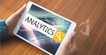 Hands holding tablet PC with analytics text in search box