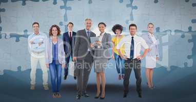 Digital composite image of business people with puzzle pieces in background