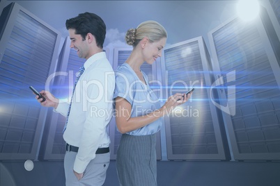 Side view of business colleagues using smart phones at data center