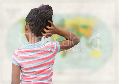 Back of girl with hand on head against blurry map
