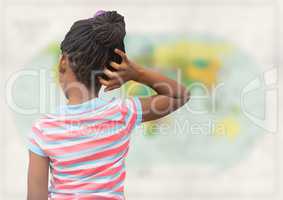 Back of girl with hand on head against blurry map