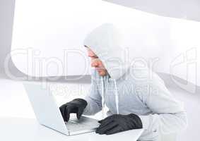 Criminal Man in hood on laptop in front of modern background