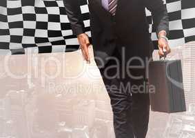 Business man lower body against skyline with flare and checkered flag