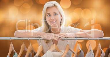 Woman leaning on clothing rack