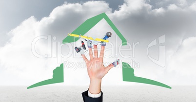 Digital composite image of hand with tools  against cloudy sky